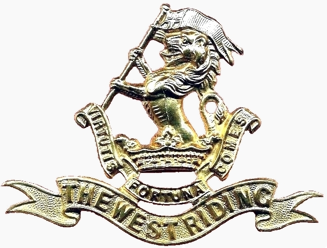 A classic soldier's cap badge, featuring a lion holding a flag, with Latin banner underneath reading Virtutis Fortuna Comes which means Fortune is the companion of virtue, above another banner reading The West Riding.