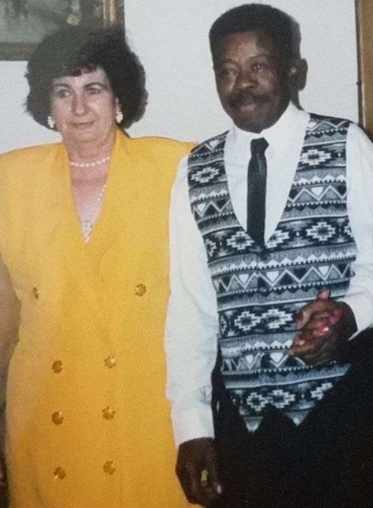 Colour photo of an obviously very happy couple. My grand aunt in a gold dress, and her husband in an impressive blank and white waistcoat.
